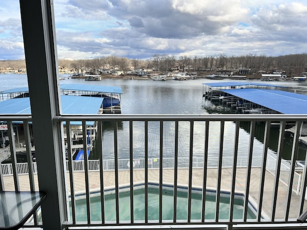 Balcony view from the LR & MBR. The included covered boat slip is also in view.