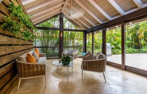 Bohio seating area off of main dining space with view of the pool