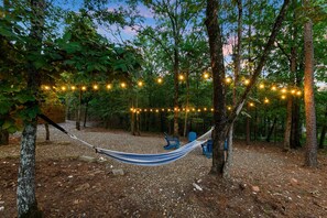 Outdoor Oasis: Relax beneath twinkling lights in this tranquil hammock retreat!
