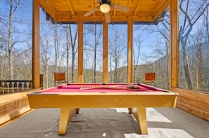 Pool table/game room surrounded by soaring windows