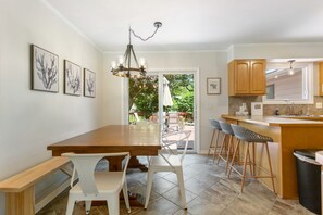 Farmhouse table with a leaf seats eight comfortably. Three stools at the counter