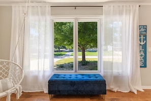 Sit at the large windows and experience the peace of the quiet neighborhood.