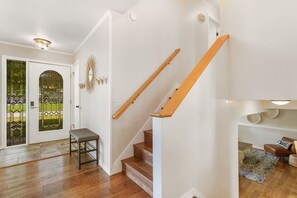 Front door entrance with shoe rack and beach towel hooks.