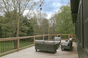 Expansive deck with stylish modern loungers to relax or read a book