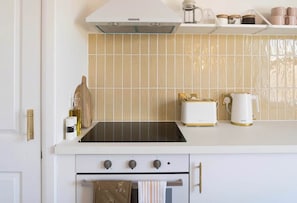 Experience the charm of a spotless and modern white kitchen.