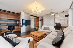 Open-plan living area with stylish wooden decor and dining space.
