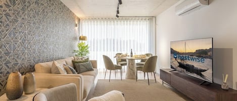 The living room is elegant with a fancy design and it has an AC for warm and cold days.