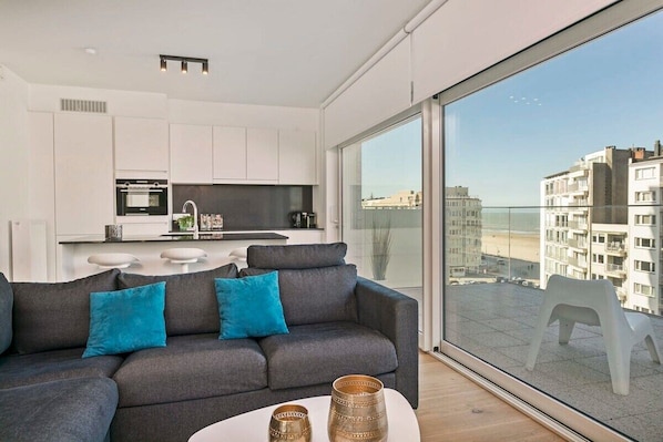 Bright, modern living room with family dining area and direct access to the outdoor space