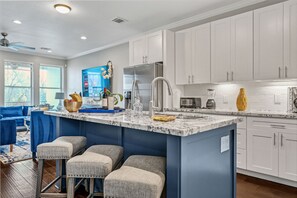 Chef's kitchen is open and airy - offers a center island with seating.  