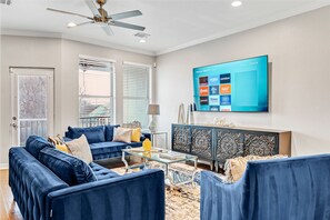 Spacious living area with an arm chair, two luxe sofas one converts to a bed!