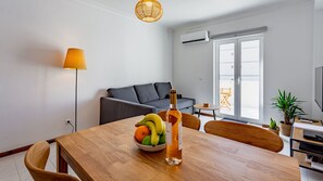 A lovely living area with a sofa-bed, cable TV, and balcony access #cozy #home #comfort #decoration