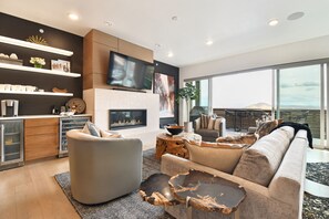 Living Room with Gas Fireplace and 65 inch Smart TV with Cable and NFL Package - Main/Upper Level