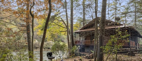 Riverside play area with firepit and grill.