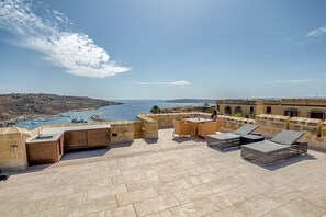 Outdoor kitchen including gas bbq loungers and outdoor furniture