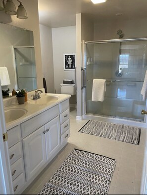 Master bath with handicap rails and large shower