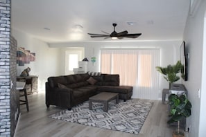 Livingroom with plenty of seating and large TV