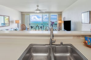 Enjoy Wailua Bay's turquoise waters through large windows as you cook, adding island beauty to your culinary experience.