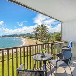 The lanai at Wailua Bay View 207 offers comfortable seating and unobstructed ocean views
