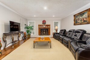 A large Smart TV in this living room immediately inside the front door on the left.