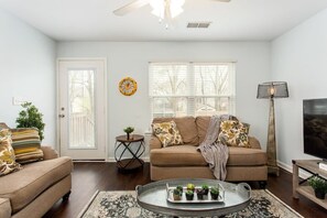 Lots of light from the large windows and door overlooking backyard.