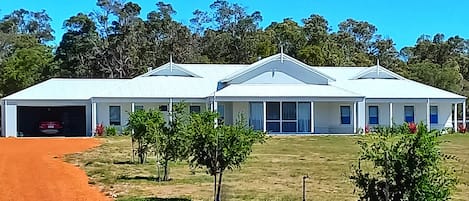 Front view of property showing driveway and garage and living areas