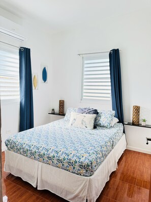 Bedroom with queen bed, double closets, luggage rack.