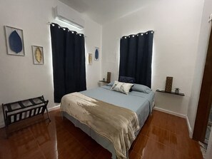 Bedroom with queen bed, double closets, luggage rack