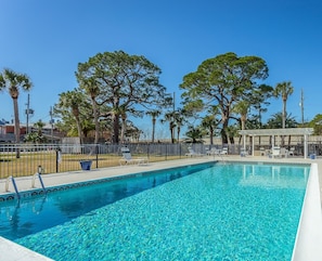 Large, beautiful pool with outdoor dining and lounging area