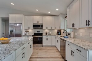 Fully stocked kitchen with coffee bar
