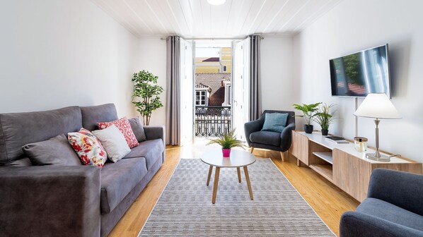 Living room with big comfortable sofa and wide screen TV in Downtown Lisbon #lisbon #airbnb #downtown