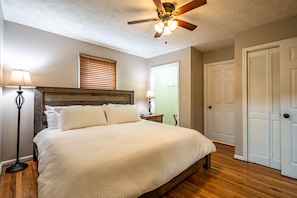The master bedroom features a big, comfortable king size bed.