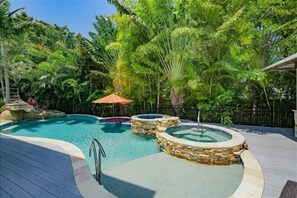 Luxury pool with spa, sun shelf, tiki bar and water slide