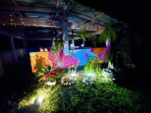 Covered entertainment area with hammocks and bbq in 1-acre backyard.