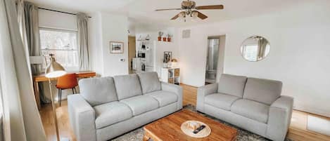 Living room with plenty of comfortable seating and an abundance of natural light.