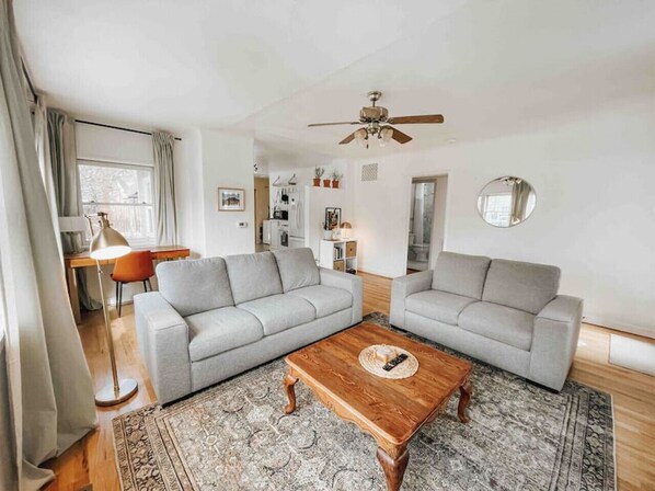 Living room with plenty of comfortable seating and an abundance of natural light.