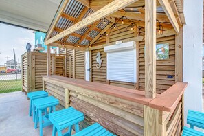 Watch the sunset from the outdoor tiki bar with lighting and seating for 6.