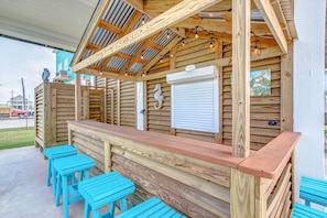 Watch the sunset from the outdoor tiki bar with lighting and seating for 6.