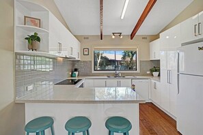 Fully equipped kitchen with basic cooking ammenities.