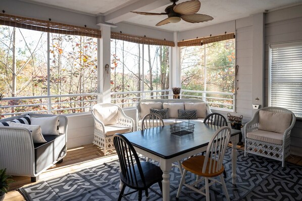 Rain or Shine - Enjoy this screened porch with dining area and 55 in HDTV!