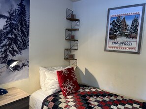 Cozy and inviting twin bed, complete with soft linens and plush pillows, perfect for a restful night’s sleep or a quiet afternoon nap. Designed for comfort and relaxation, this space is ideal for unwinding after a long day of adventures.