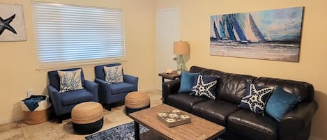 Welcome to Simply Beachy.  Living area has a Murphy bed and sleeper sofa.