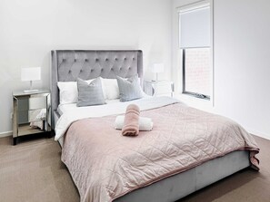 Master bedroom with large window and cable TV