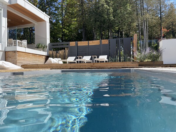 Private lounging backyard with landscaping.