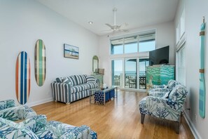 Living room, first floor, opens to balcony dining and stair to patio on ground floor.