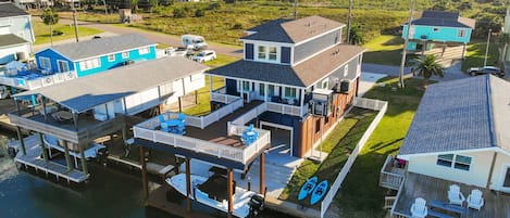 Aerial view showing the proximity to the beach and sprawling deck.