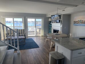 Open kitchen/dining/living area; with deck and views beyond