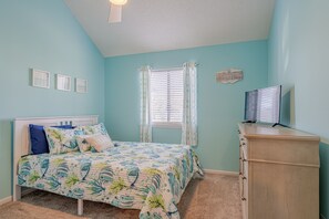 Downstairs bedroom with a queen and twin bunk bed with trundle. 