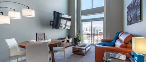 Living Room with a Large 75" TV, Vaulted Ceiling Windows & Sleeper Sofa