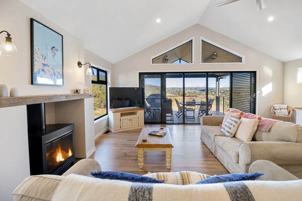Beautiful open plan living, with wooden floors, pitched roof and gas wood burner