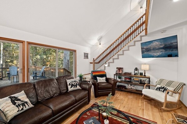 Living Room with leather furniture and wood stove.